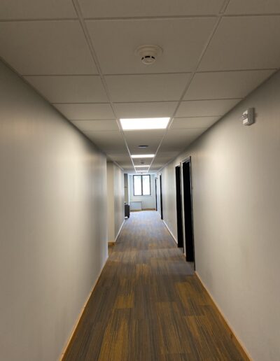 A hallway with suspended ceilings. Sound dampening ceiling panels.